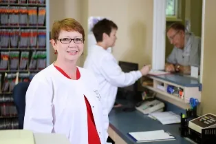Front office staff member behind desk
